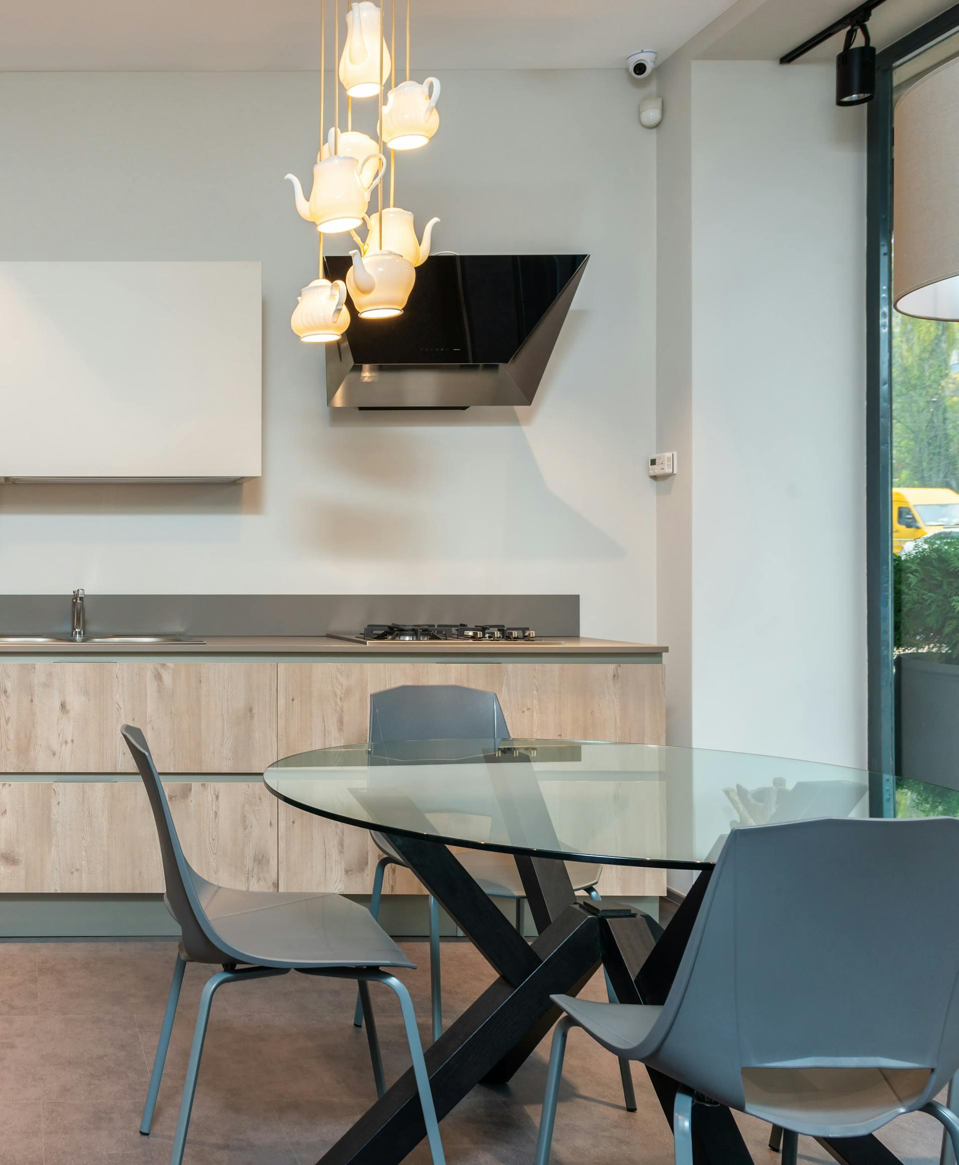 The empty and clean property with a glass dining table in the kitchen